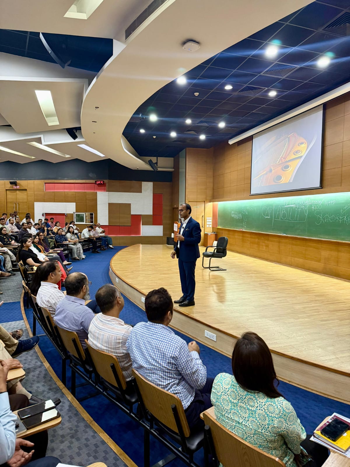 Amit speaking at a conference
